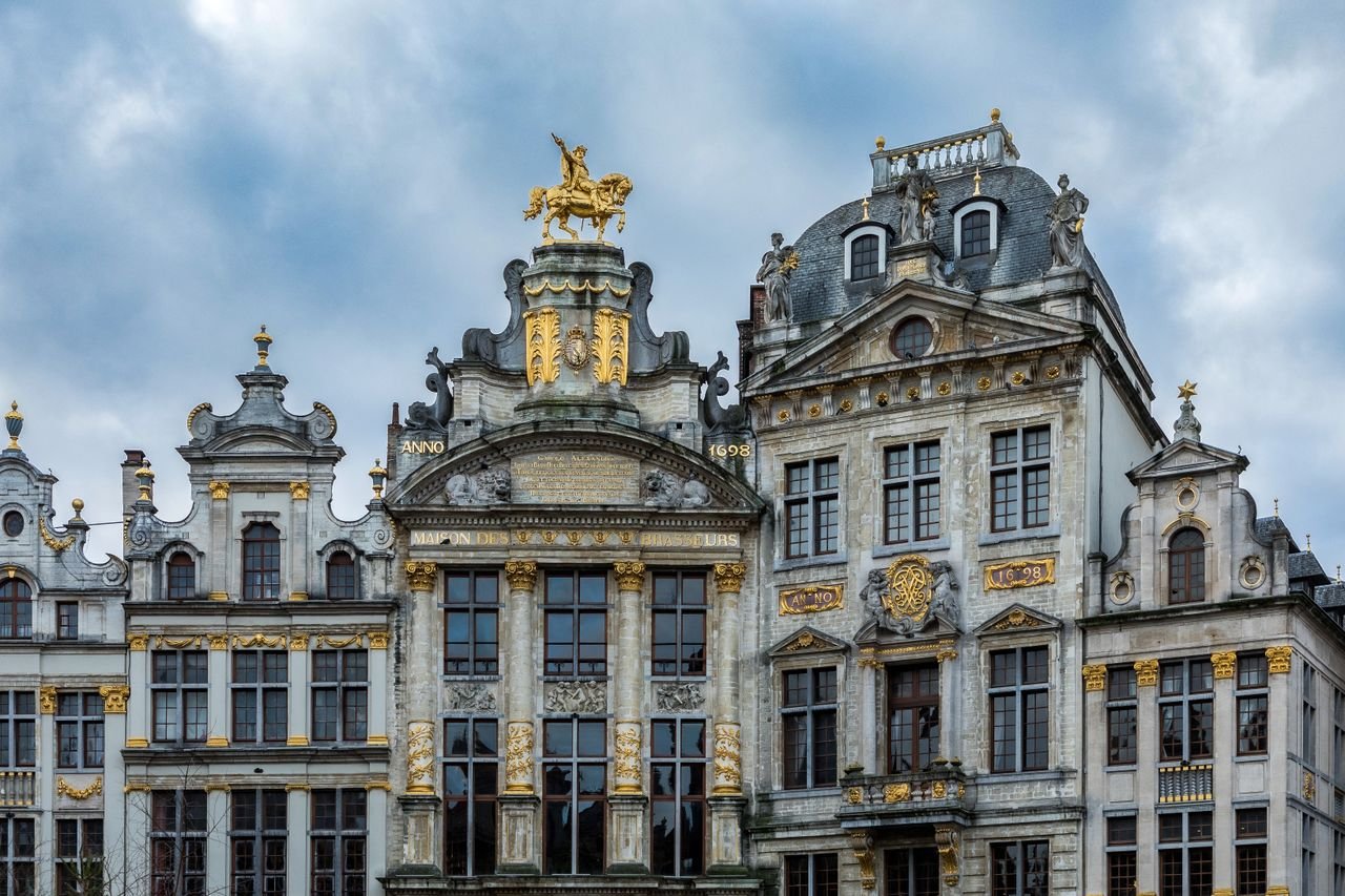 The Art of Drawing Readers In: Your attractive post title goes here Beautiful ornate buildings at the Grand Place in Brussels, showcasing Baroque style architecture under a cloudy sky.